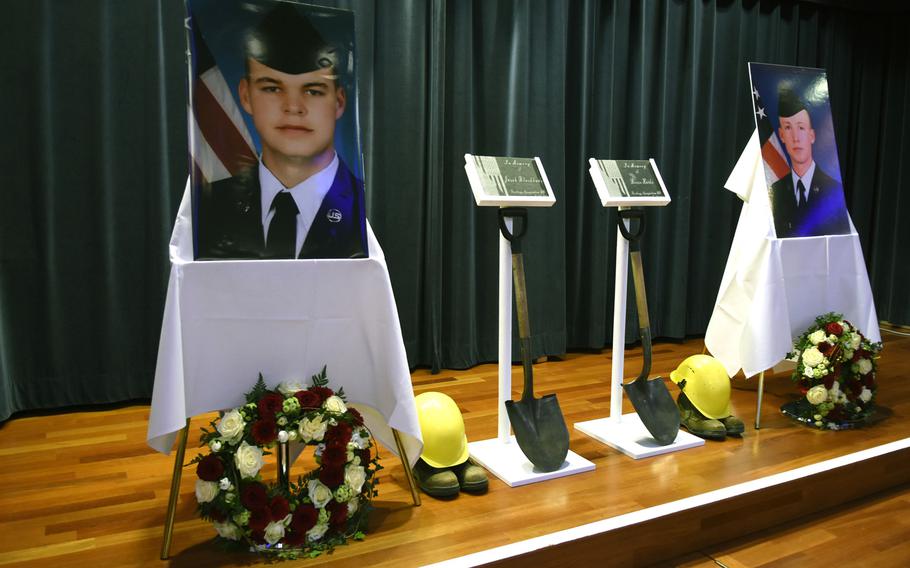 The stage inside the Club Eifel ballroom at Spangdahlem Air Base, Germany, was set up in tribute to Airman 1st Class Jacob A. Blackburn, photograph on left, and Airman 1st Class Bradley Reese Haile, Oct. 22, 2019. The hard hats and shovels represent the ''Dirt Boyz,'' a nickname given to airmen working in heavy equipment and pavement shops.