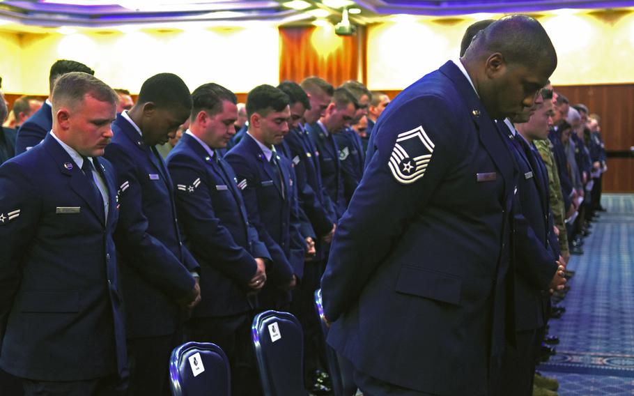 Airmen bow their heads in prayer during a memorial service for Airmen 1st Class Jacob A. Blackburn and Bradley Reese Haile on Tuesday, Oct. 22, 2019, at Spangdahlem Air Base, Germany. Blackburn and Haile were killed in a car crash on base last month.