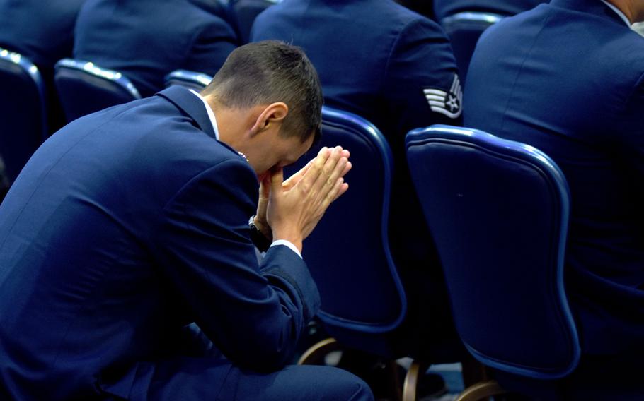 An airman prays during a memorial service for Airmen 1st Class Jacob A. Blackburn and Bradley Reese Haile on Tuesday, Oct. 22, 2019, at Spangdahlem Air Base, Germany. Blackburn and Haile were killed in a car crash on base last month.