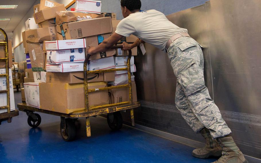 A U.S. Air Force airman pushes a cart of parcels at Ramstein Air Base, Germany's North Side Post Office in 2017. Space-available mail coming from the U.S. to Air Force postal offices in Germany, Belgium and the Netherlands will take around 30 to 45 days to arrive during the upcoming holiday season.
