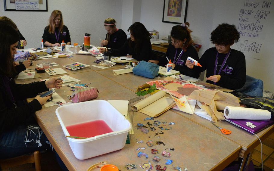 Students in the collect, converge, create, collage workshop at this year's Creative Connections in Oberwesel, Germany, work on collages using traditional art materials in nontraditional ways.