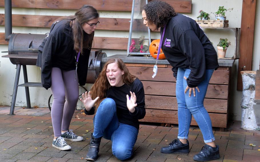 Spangdahlem's Jolie Haar screams as Rota's Helen Quast, left, and Bahrain's Jasmine Osman put her down, saying she has stage fright, as they act out a piece in the drama workshop at Creative Connections.