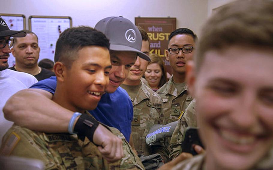 Mark Wahlberg meets with troops at the Fort Benning exchange store in May 2018. Wahlburgers, the fast-casual restaurant founded by executive chef Paul Wahlberg and brothers Mark and Donnie Wahlberg, will open its first location on a military installation at Ramstein Air Base, Germany.