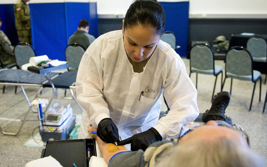 U.S. Army Staff Sgt. Christina Gomez draws blood from a donor at Ramstein Air Base, Germany in 2018. The Armed Services Blood Program Europe put out a call for specific blood types for U.S. service members deployed to Africa, asking for people to donate at a blood drive this week at Landstuhl Regional Medical Center.