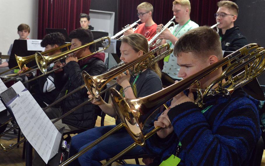 The big band trombone section practices a song at the 2020 DODEA-Europe Jazz Festival in Kaiserslautern, Germany, Jan. 14, 2020.