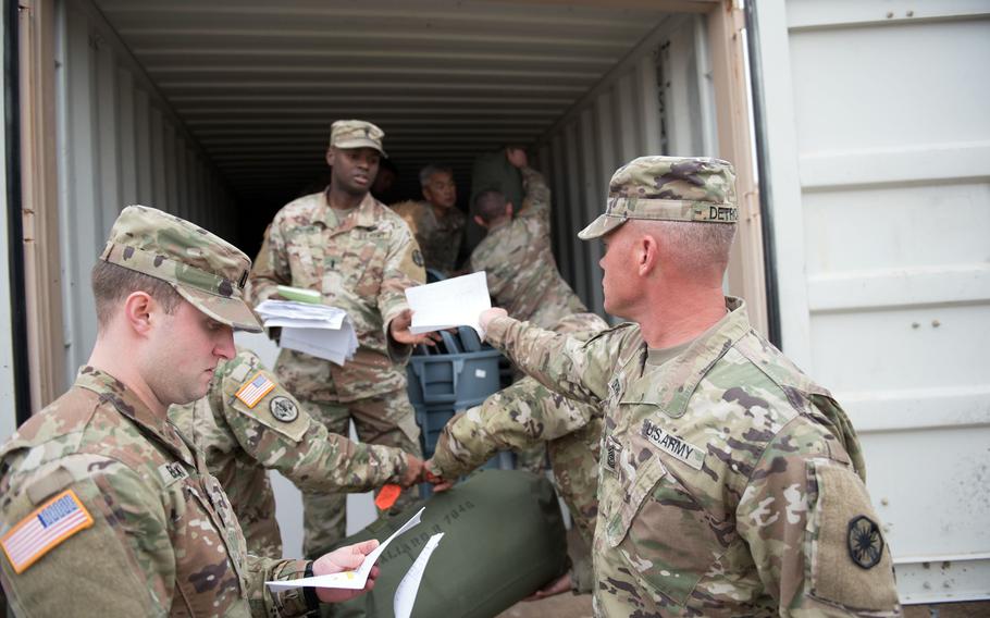 Sgt. Maj. Erick M. Detrich, 13th Expeditionary Sustainment Command, hands in his duffle bag inventory sheet as he loads his bag into a connex at Fort Hood, Texas, Jan. 13, 2020. The loading of tanks and other gear for transport to Europe, due to begin Jan. 23, marks the beginning of Defender-Europe 20, the largest exercise on the Continent for U.S. forces in 25 years.