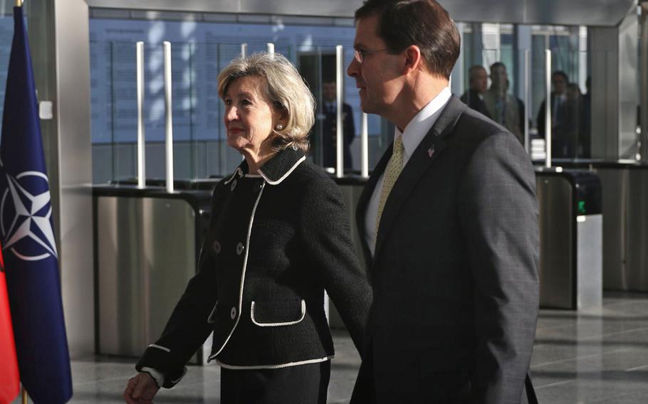 Secretary of Defense Mark Esper walks with U.S. Permanent Representative to NATO Kay Bailey Hutchison before the start of a two-day meeting of defense ministers at the alliance's headquarters in Brussels, Feb 12, 2020.