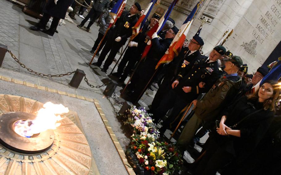 Stephen Weiss, with a cane, speaks with Special Forces Lt. Col. Travis Moliere, following a ceremony to rekindle the Eternal Flame at Paris's Tomb of the Unknown Soldier under the Arc de Triomphe on Friday, Feb. 14, 2020. Weiss, 94, is a World War II veteran who had worked with the Office of Strategic Services, a precursor to Special Operations Command, conducting unconventional warfare behind Nazi lines in France during World War II. He and Moliere, along with Josephine Ligout, far right, a French-American high school student living in Chevy Chase, Md., laid a wreath at the tomb during the event.