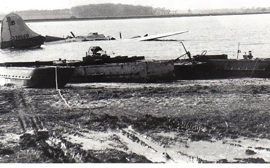The B-17 Flying Fortress that crashed on Feb. 20, 19945 in the Deben River near the east coast of England is shown just prior to being hauled ashore by recovery barges.  Eight of the bomber's crew of 10 died in the crash, which happened shortly after the plane took off on a mission to Nuremberg, Germany.