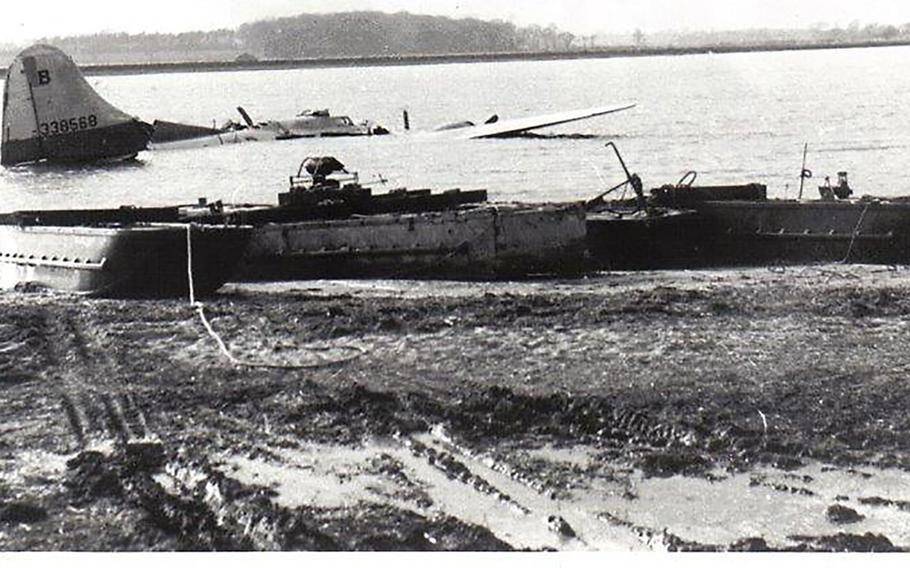 The B-17 Flying Fortress that crashed on Feb. 20, 19945 in the Deben River near the east coast of England is shown just prior to being hauled ashore by recovery barges. Eight of the bomber's crew of 10 died in the crash, which happened shortly after the plane took off on a mission to Nuremberg, Germany.