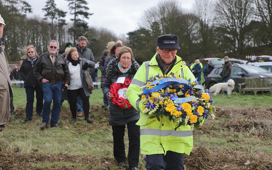 Harbormaster George Collins leads family members of the crew of a B-17 Flying Fortress that crashed in the Deben River near the east coast of England on Feb. 20, 1945, to lay wreaths of remembrance near the spot where bomber came down, on Feb. 20, 2020.