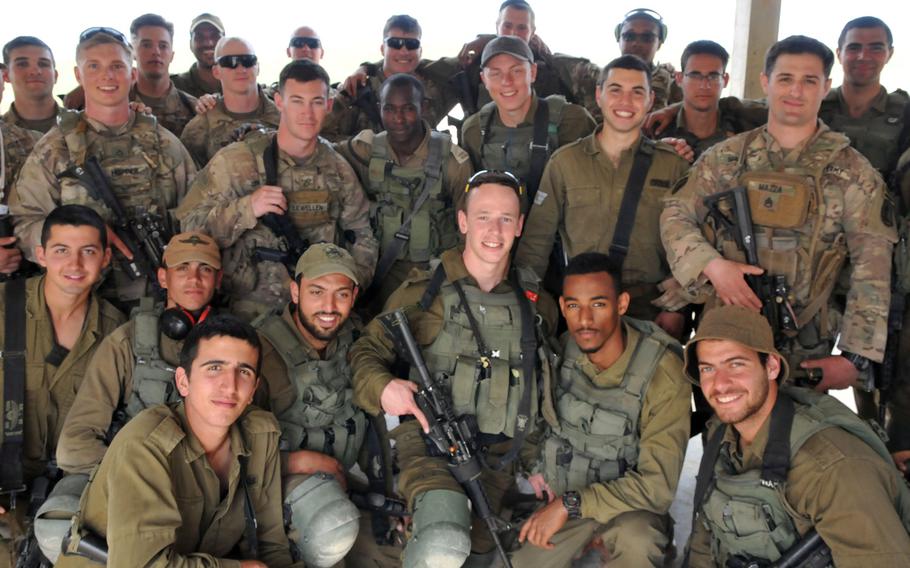 Soldiers with the Vicenza, Italy-based 173rd Airborne Brigade and Israeli Defense Forces soldiers with the 890th Airborne Battalion pose for a photo during training in March 2019 in Israel. Vicenza-based troops who went to Israel last week returned to Italy after an exercise was canceled due to coronavirus-related travel restrictions.