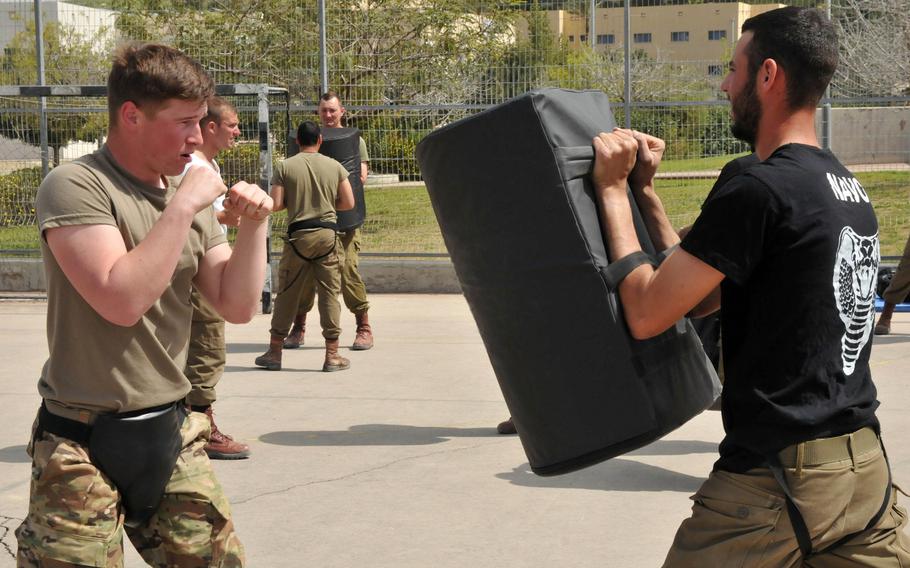 A soldier with the Vicenza, Italy-based 173rd Airborne Brigade and an Israeli soldier with the Israeli Defense Forces 890 Airborne Battalion practice hand-to-hand combat in March 2019 in Israel. Vicenza-based troops who went to Israel last week returned to Italy after an exercise was canceled due to coronavirus-related travel restrictions.