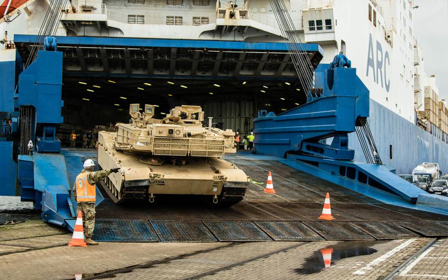 Army Lt. Col. William Prince Jr., commander of the 838th Transportation Battalion, 598th Transportation Brigade, guides an M1A1 Abrams tank off of the ARC Endurance and onto the port of Bremerhaven, Germany, Feb. 20, 2020, officially moving the first piece of U.S.-shipped equipment that will be used in Defender Europe.