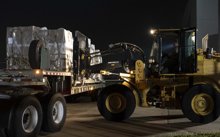 An air crew from Travis Air Force Base, Calif., and the 164th Airlift Wing unload coronavirus testing swabs at the Memphis Air National Guard Base, Tenn., March 19, 2020. About 500,000 testing swabs and supplies were flown from Aviano Air Base, Italy to Memphis, to be distributed to medical facilities across the country.