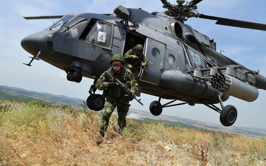 Belarus military members exit an Mi-8 helicopter during a training exercise, in an undated photo. Belarus will go ahead with its military drills in response to Defender-Europe 20, even though the U.S. led exercises were scaled back.
