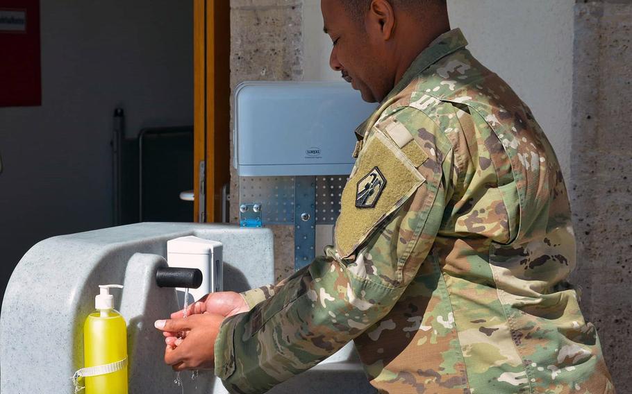 A soldier uses a hand-washing station in Stuttgart in March, one measure taken to stem the spread of the coronavirus at an Army garrison with more than 100 confirmed COVID-19 cases.