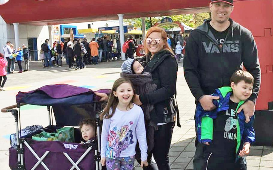 Brittany Frias, center, with her husband, Staff Sgt. Chris Frias, right, and their children at Legoland in Munich, Germany, May 2019, for their oldest son's birthday. Brittany Frias is managing the household, a task made more challenging by coronavirus restrictions, while her husband remains on an extended deployment.