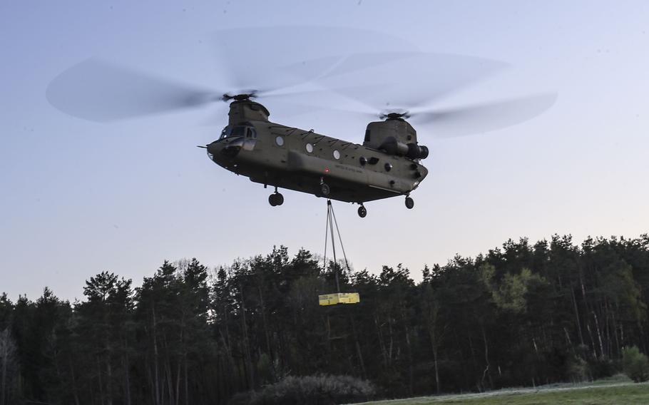 A pilot with the 12th Combat Aviation Brigade lifts a sling load training block during a pilot progression training exercise on Ansbach, Germany, April 20, 2020. The training went ahead, with modifications, in spite of the coronavirus pandemic.