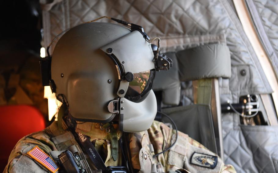 Sgt. Matthew Cullen, a flight engineer with the 12th Combat Aviation Brigade, looks out of a CH-47 Chinook helicopter during a pilot progression training exercise on Ansbach, Germany, April 20, 2020.