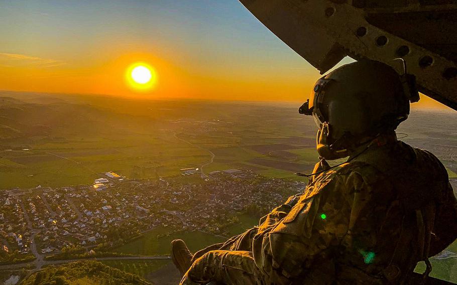 Sgt. 1st Class Manuel Reyes, a crew chief with the 12th Combat Aviation Brigade, looks out of a CH-47 Chinook helicopter during a pilot progression training exercise on Ansbach, Germany, April 20, 2020. The training went ahead, with modifications, in spite of the coronavirus pandemic.