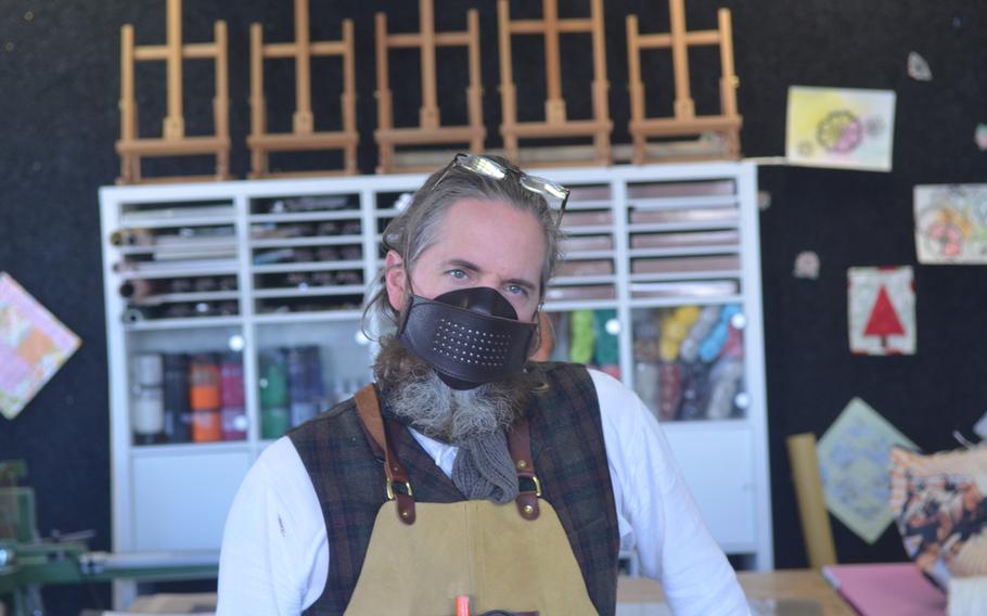 Erik Kraemer, manager at Wiesbaden Arts and Craft Center, Germany, takes a break from making face masks for the local military community on April 17, 2020. 