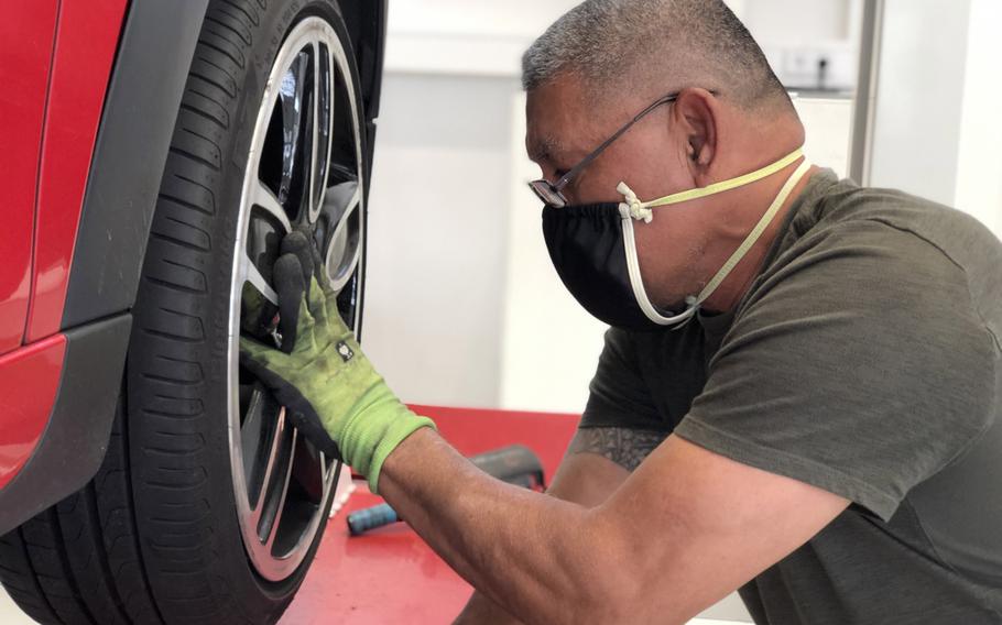 A Family Morale, Welfare and Recreation auto skills worker on Panzer Kaserne, Stuttgart, Germany, changes a tire, April 21, 2020. A two-week stretch with no new coronavirus cases ended April 29 for the garrison, its commander said.