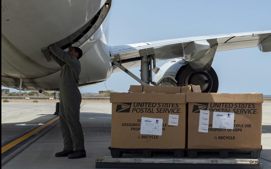 Petty Officer 2nd Class Stephen Williams, assigned to Fleet Logistics Support Squadron 58, prepares cargo spaces before loading mail bound for Europe aboard a C-40A aircraft at Camp Lemonnier, Djibouti, April 22, 2020.