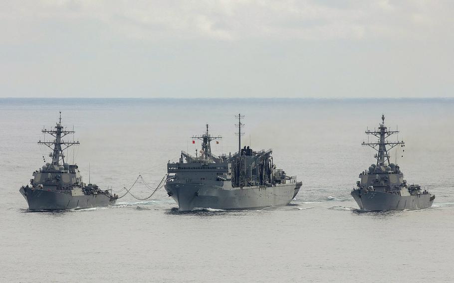 The U.S. Navy destroyers USS Porter, left, and USS Donald Cook, right, replenish from the fast combat support ship USNS Supply while operating with the Royal Navy frigate HMS Kent, not pictured, above the Arctic Circle during a bilateral anti-submarine exercise in the North Sea, April 28, 2020.