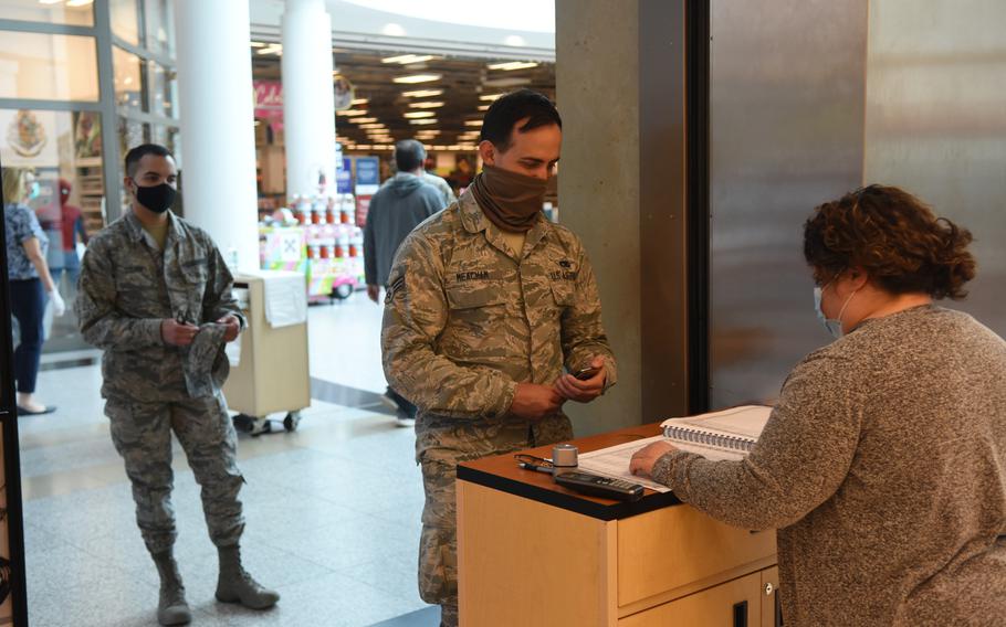 U.S. servicemembers wait in line to make an appointment for a haircut at the base mall on Ramstein Air Base, Germany, on Monday, May 4, 2020. No walk-in service is currently available.