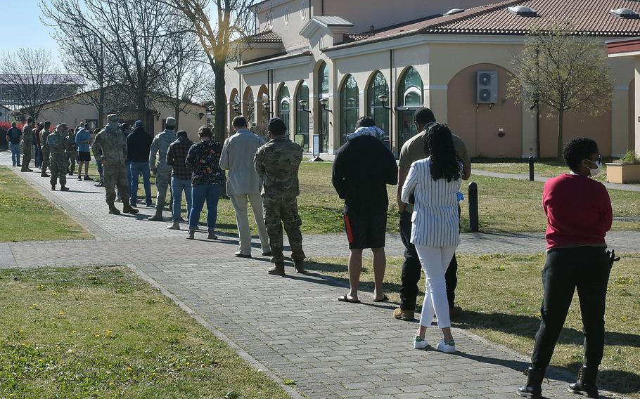 More than 70 people stand in line outside the post office building at Aviano Air Base, Italy, last month. Italy on Monday eased some coronavirus restrictions, which had been in place for as long as late February. Americans will, for now, see little change on U.S. bases in the country.