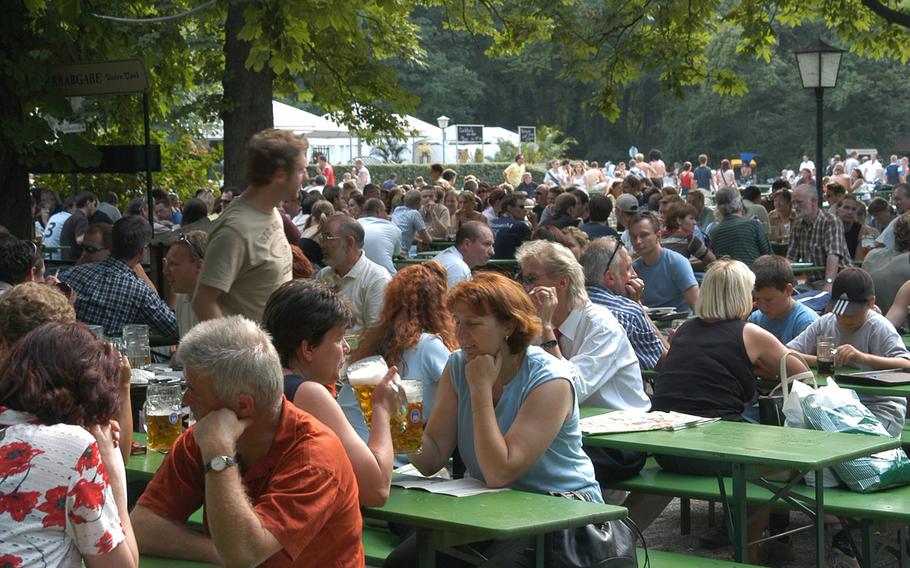 People relax in a beer garden in Munich, Germany, in this file picture taken before the coronavirus pandemic. Restaurants and beer gardens will be reopening soon across the country with social distancing and hygiene rules to prevent a resurgence of the virus. But some U.S. service members might not be as free as their German counterparts to enjoy the reopenings.