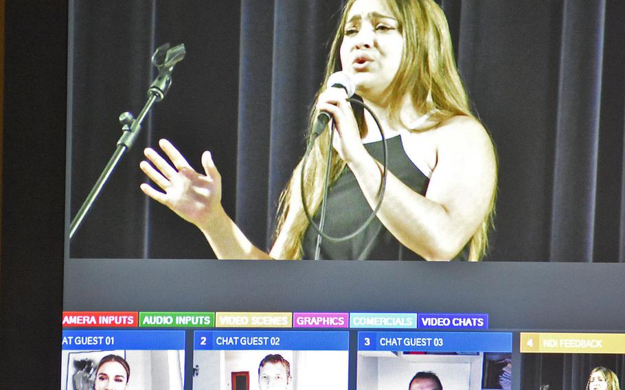 A monitor captures Breeanna Martens performing in the first round of Aviano Idol on Monday, May 11, 2020, while three judges watch from their homes.