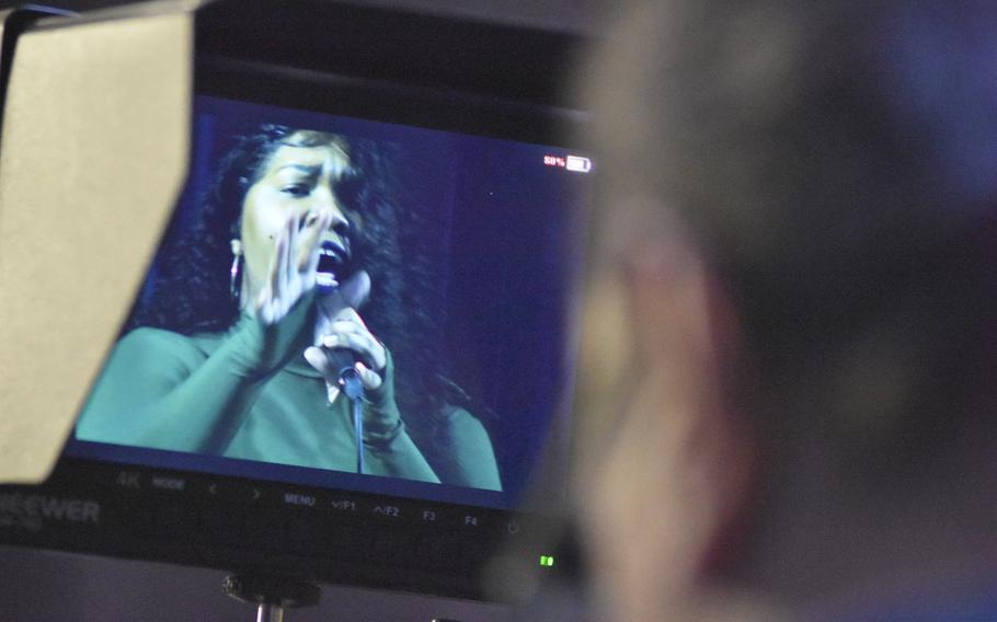 A cameraman captures Staff Sgt. Nia Newton during her performance in the Aviano Idol competition on Monday, May 11, 2020. An Italian production company is filming the three-week competition in front of an almost-empty Aviano Air Base theater to produce a series airing Fridays on the base's Facebook page this month.