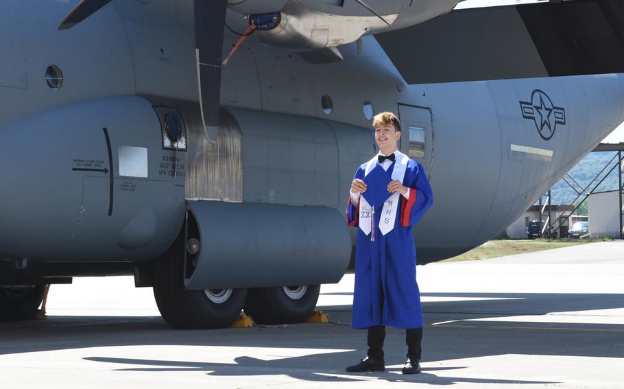 Ramstein senior Matthew Oreskovich, 18, gets his photo taken in his cap and gown in front of a C-130J Super Hercules at Ramstein Air Base, Germany, on May 18, 2020. The Air Force and the schools collaborated on the plan to do something special for seniors missing out on the traditional high school graduation ceremony due to the pandemic.