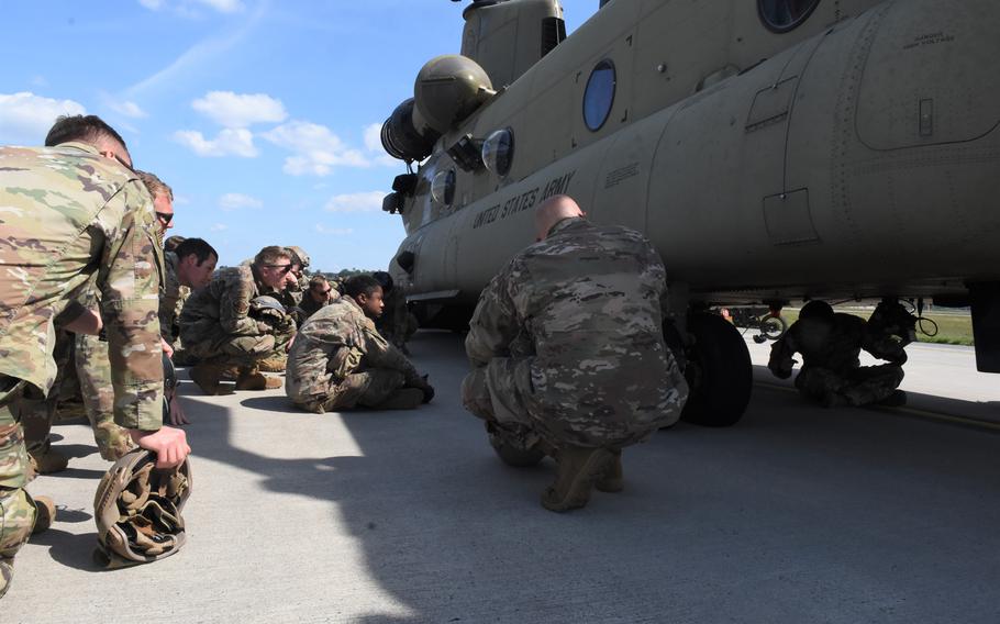 Airmen with the 435th Contingency Response Squadron gather around an Army CH-47 Chinook helicopter at Ramstein Air Base, Germany, on Wednesday, May 27, 2020. The helicopter flew from Katterbach Army Airfield for the Agile Wolf exercise.