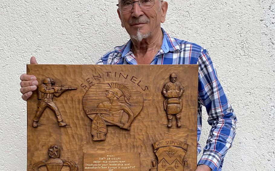 German woodcarver Sebastian Demmel holds one of thousands of carvings he has made for American service members over the past five decades. His carvings have earned Demmel a nomination as an honorary Green Beret. He would be the first German to be honored in this way.