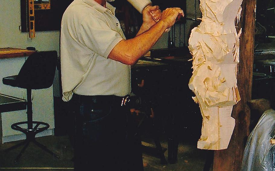 Sebastian Demmel works on a statue of Jesus Christ for a church in Lake View, Iowa. Demmel, from a small village in Bavaria, was nominated this year to become an honorary Green Beret, in recognition of the thousands of wood carvings he has made over the years for Special Forces soldiers based in Germany.