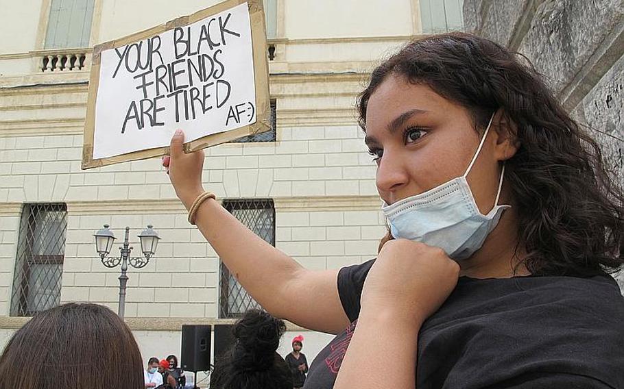 An Italian woman at a protest in Vicenza, Italy on Saturday, June 6, 2020, held a sign expressing the fatigue black people are experiencing after centuries of exploitation, discrimination and state-sponsored violence. The other side said,"I Love Being Black. S--t Dangerous But It's Lit."