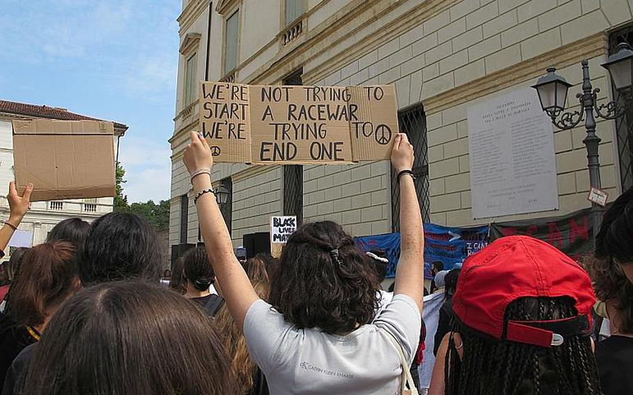 Protesters in Vicenza, Italy on Saturday, June 6, 2020 against U.S. racism and police brutality, sparked by the police killing of George Floyd, held aloft variety of signs as they listened to speakers and singers.