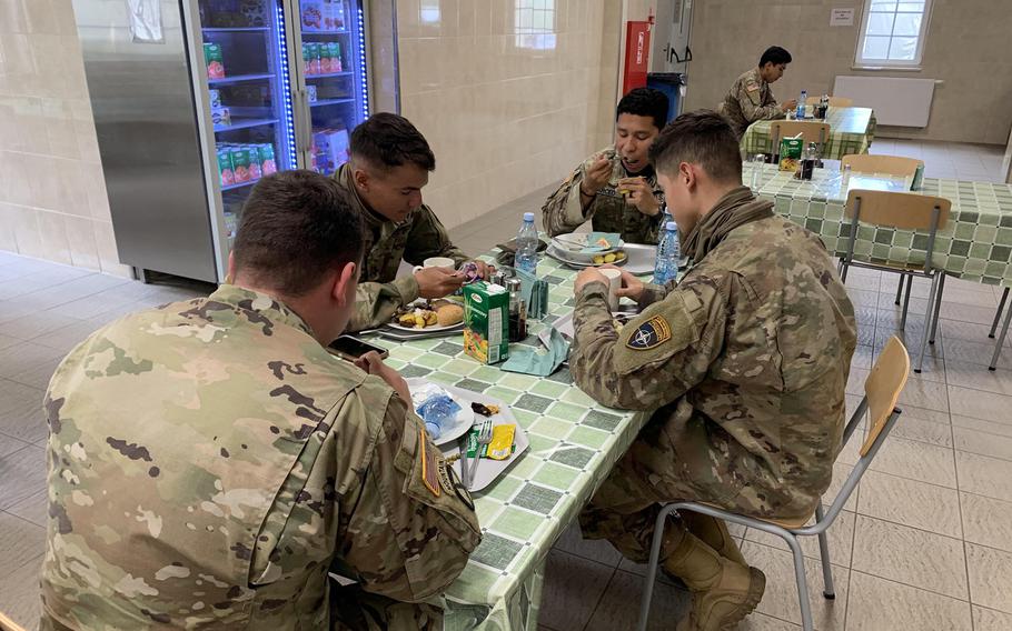 Soldiers with the Enhanced Forward Presence Battle Group eat their lunch at the dining facility on Bemowo Piskie Training Area in Orzysz, Poland, on June 3, 2020. In the White House's plan to remove 9,500 troops from Germany, some would move to Poland, The Wall Street Journal reported Friday.