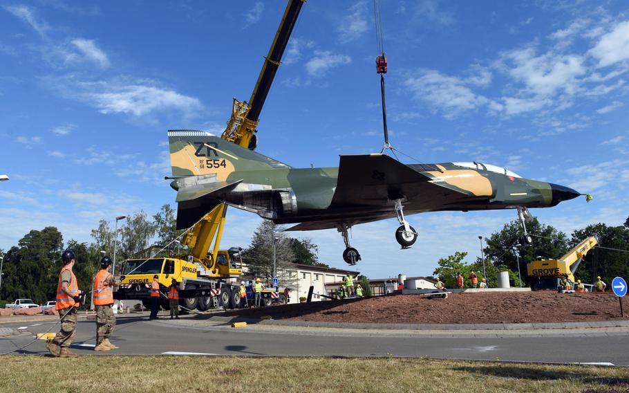 Personnel at Ramstein Air Base, Germany, help move a refurbished F-4 Phantom fighter jet to the traffic circle by the northside gym on Monday, June 8, 2020, where it is on static display.