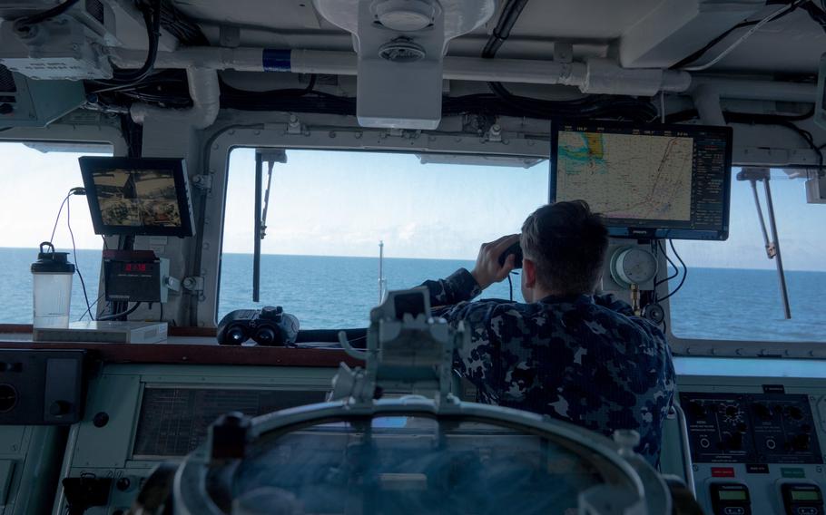 A sailor aboard the Lithuanian navy ship LNS Skalvis observes NATO allies and partner nation ships during Baltic Operations 2020, or BALTOPS.