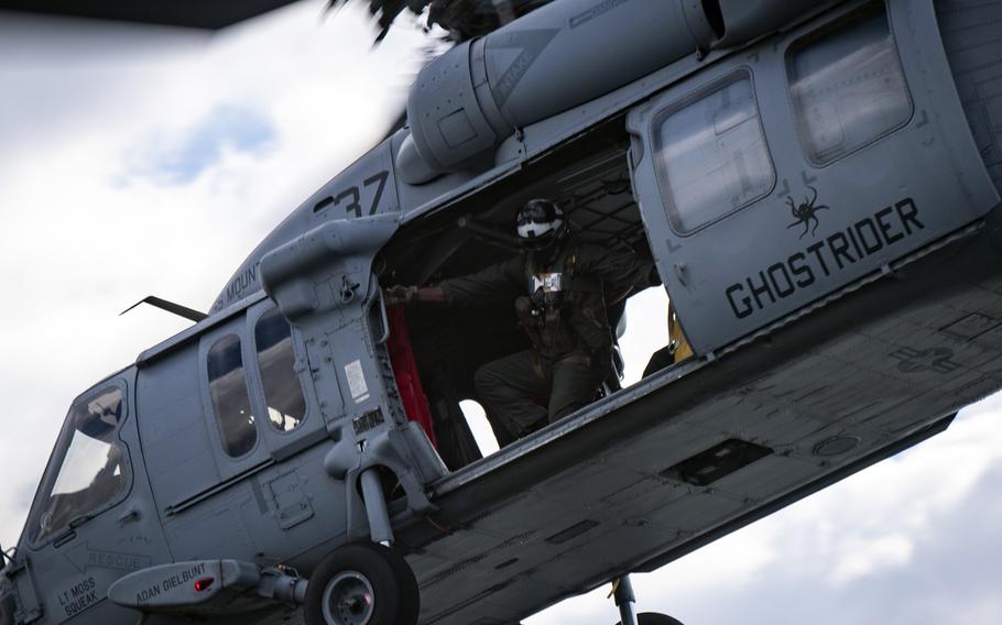 Petty Officer 1st Class Ronald Cook, assigned to the Dragon Whales of Helicopter Sea Combat Squadron 28, closes the side door of an MH-60 Seahawk helicopter after takeoff from the command and control ship USS Mount Whitney in the Baltic Sea, June 7, 2020. Mount Whitney is currently participating in Baltic Operations 2020, or BALTOPS.