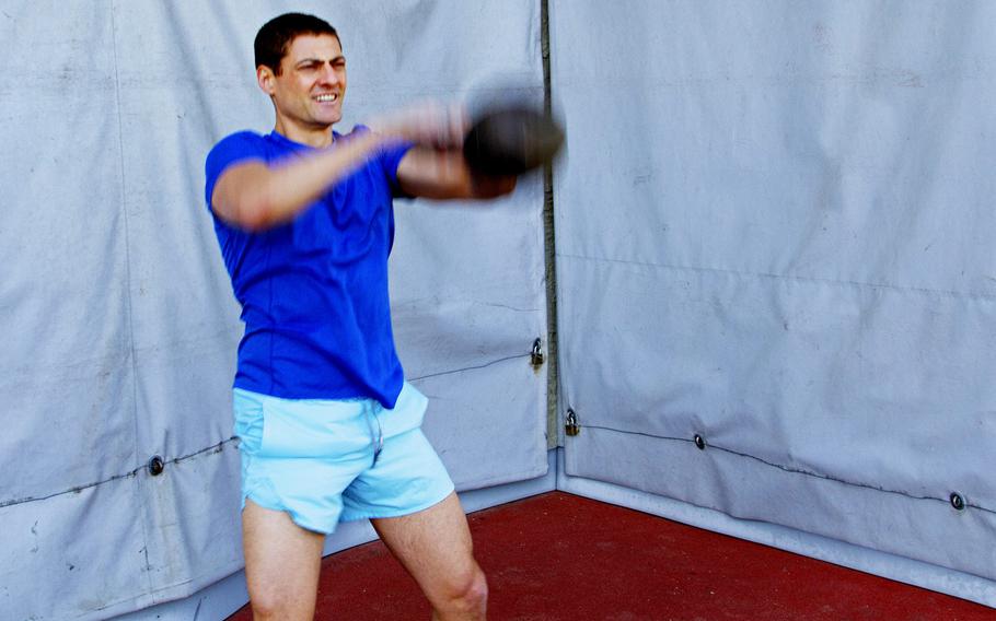 U.S. Army Lt. Col. Eric Palicia works out with a kettlebell on Clay Kaserne, Germany, on April 21, 2020. Palicia and his brother, Air Force Capt. Noah Palicia, stationed at Yokota Air Base, Japan, are now competing on "The Titan Games," which is airing on NBC.