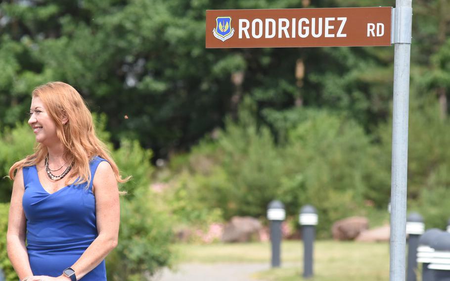 Caryn Rodriguez stands next to the road sign named after her late husband, Air Force Maj. Rodolfo Rodriguez. The newly paved road at Ramstein Air Base, Germany, was dedicated to Rodriguez at a ceremony on Tuesday, June 16, 2020. 