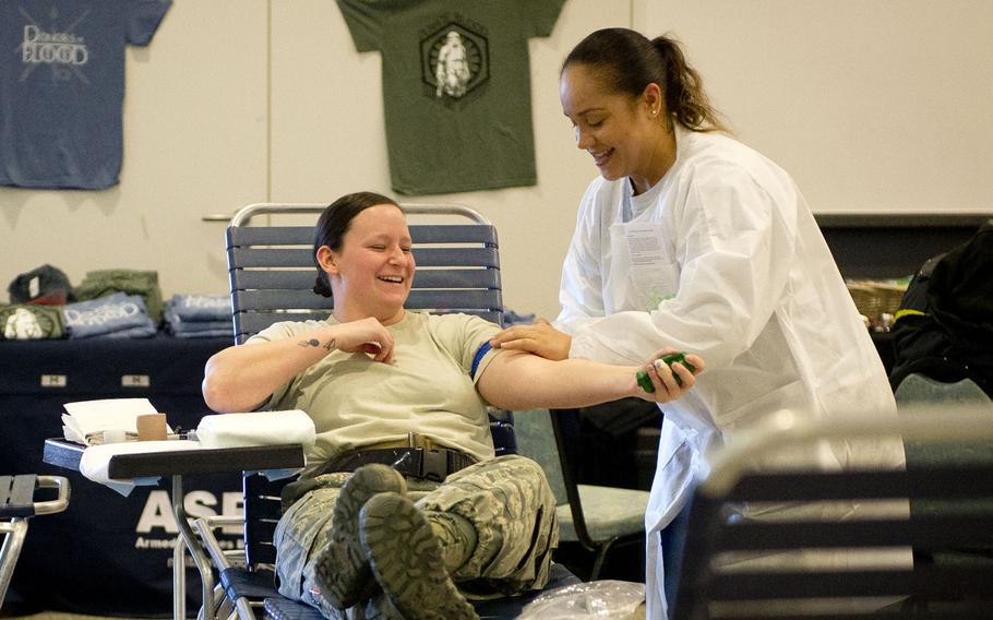 Lena Sapp, a medical technologist from Landstuhl Regional Medical Center, right, applies a tourniquet to Senior Airman Jordan Burge during a blood drive at Ramstein Air Base, Germany in February 2018. The Food and Drug Administration has loosened restrictions on who can give blood, making potentially thousands more troops, veterans and retirees who have lived in Europe eligible to donate.