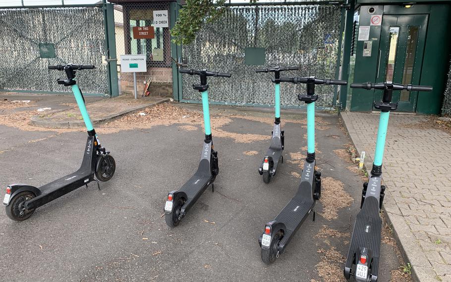 Electric motorized scooters stand outside the gates of Kleber Kaserne in Kaiserslautern, Germany, on Tuesday, June 30, 2020. Riding an e-scooter under the influence can be costly in terms of civilian and military punishment.