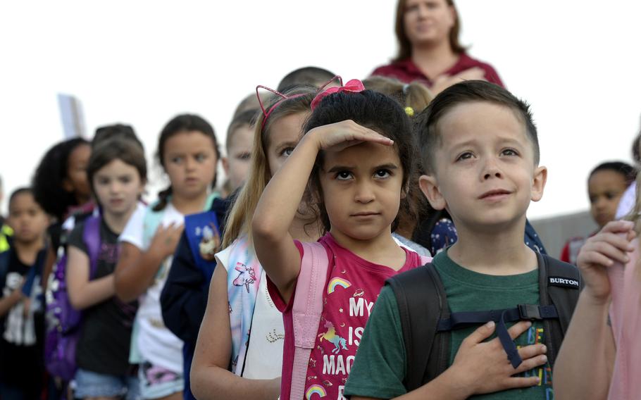 Students salute the flag during the national anthem on the first day of school at Vogelweh Elementary School, in Kaiserslautern, Germany, in August 2019. The Department of Defense Education Activity plans to open all schools as scheduled for the 2020-21 school year, as long as local health conditions are favorable.