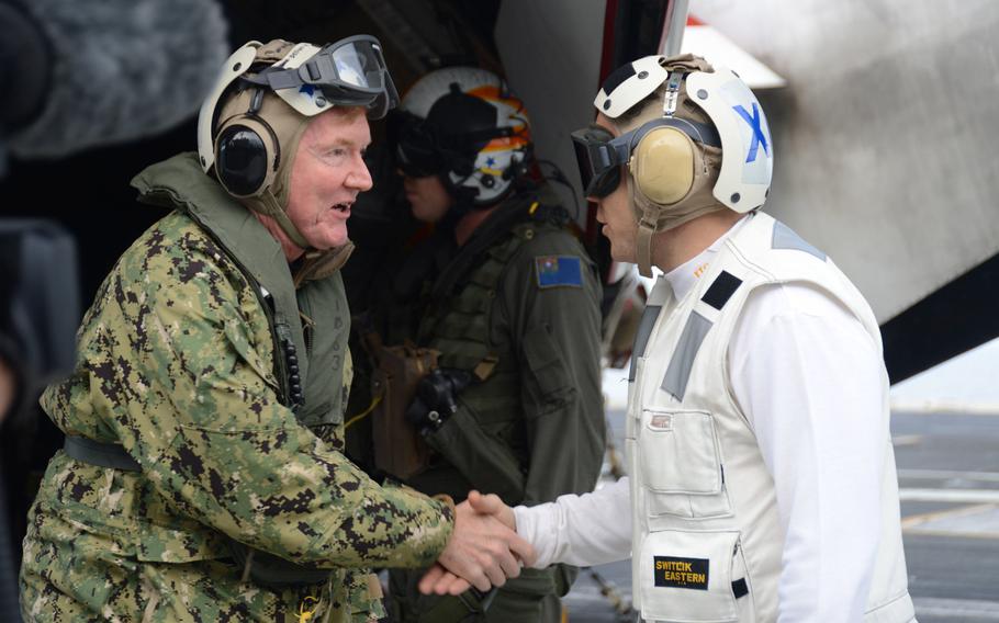 Adm. James G. Foggo III shakes hands with Capt. Daniel Prochazka, the executive officer of the aircraft carrier USS Harry S. Truman, on the flight deck in the Mediterranean Sea Dec. 9, 2019. Foggo relinquished command July 17, 2020, of U.S. Naval Forces Europe-Africa.